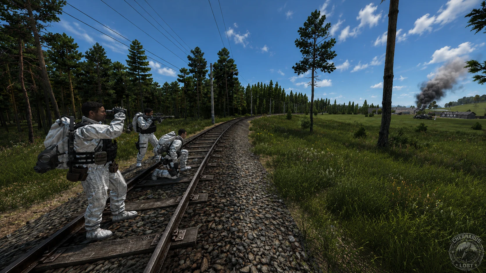 Three survivors observing the countryside from railway tracks.