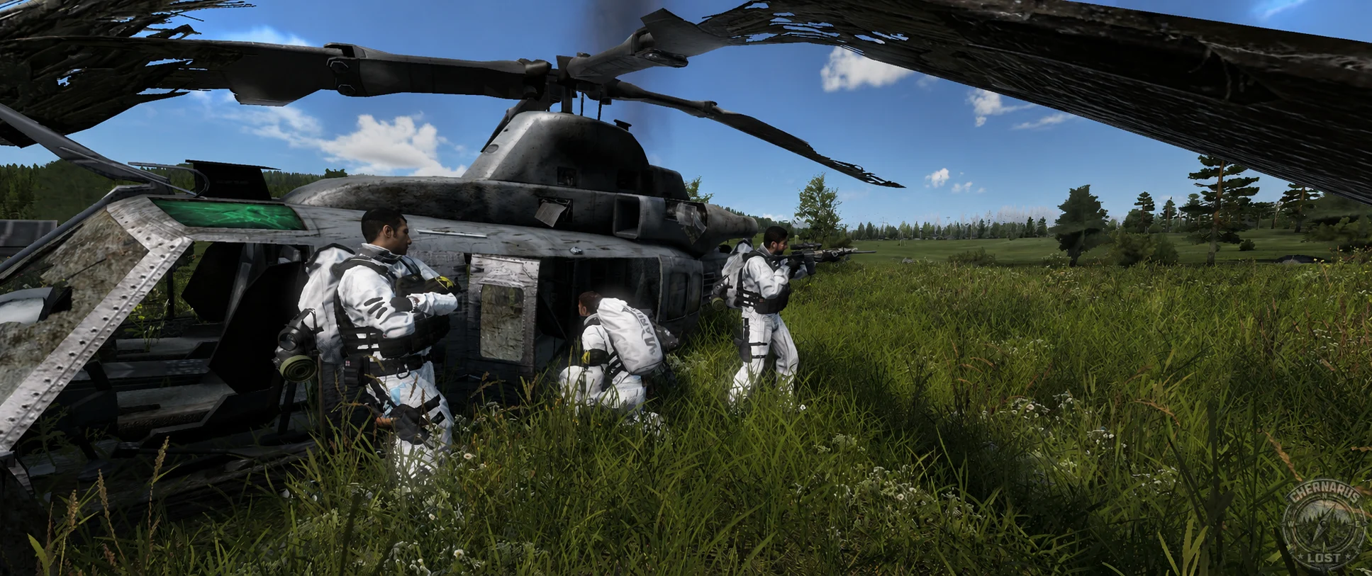 Three survivors in white clothing beside a wrecked military helicopter in a field.